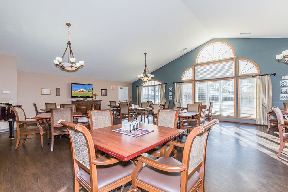 Elegant dining room complete with chandliers at Brookstone Estates of Mattoon North in Mattoon, Illinois