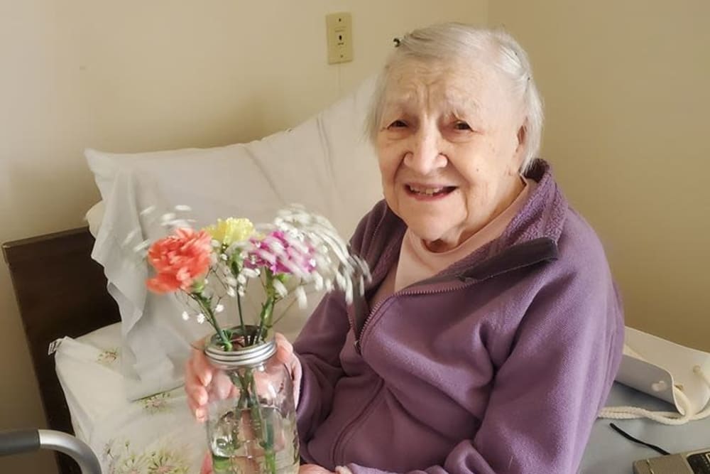 Resident with flowers at Victory Centre of Joliet