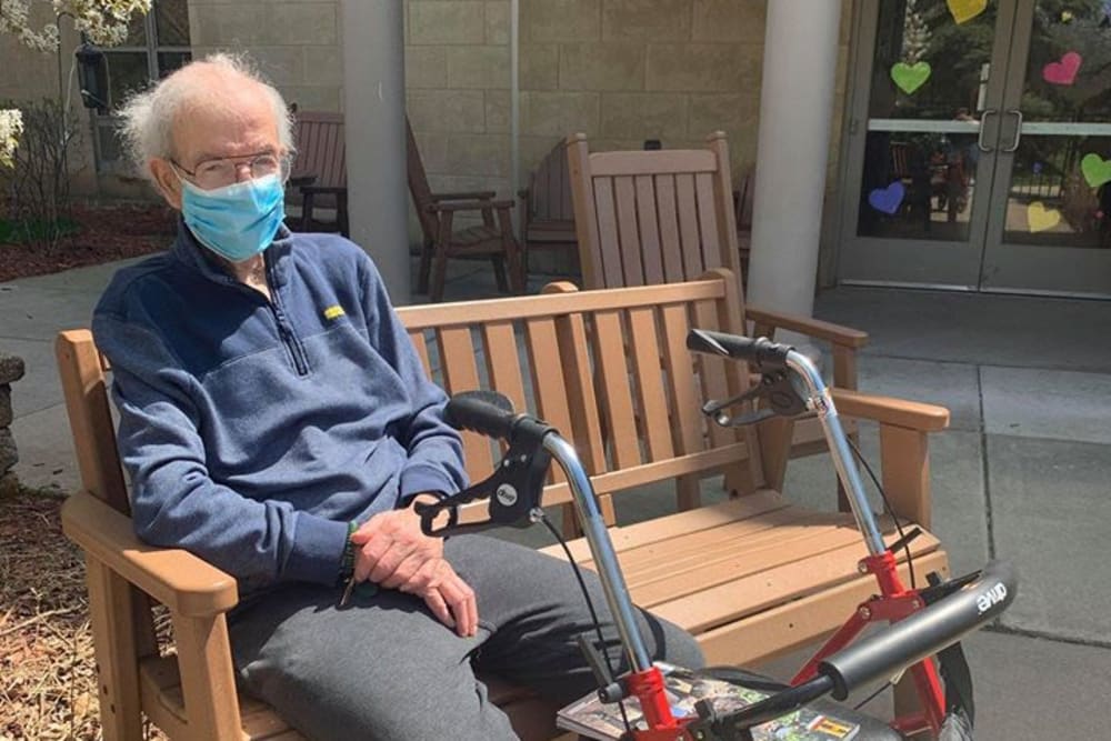 Resident sitting outside at Victory Centre of River Woods 