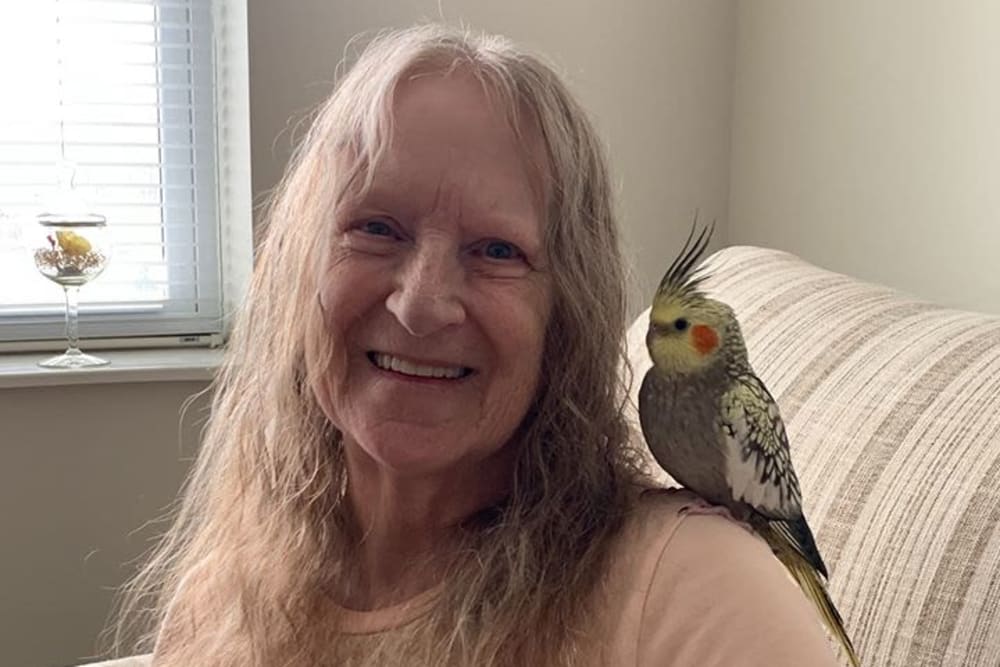 Resident with bird at Oak Hill Supportive Living Community in Round Lake Beach, Illinois