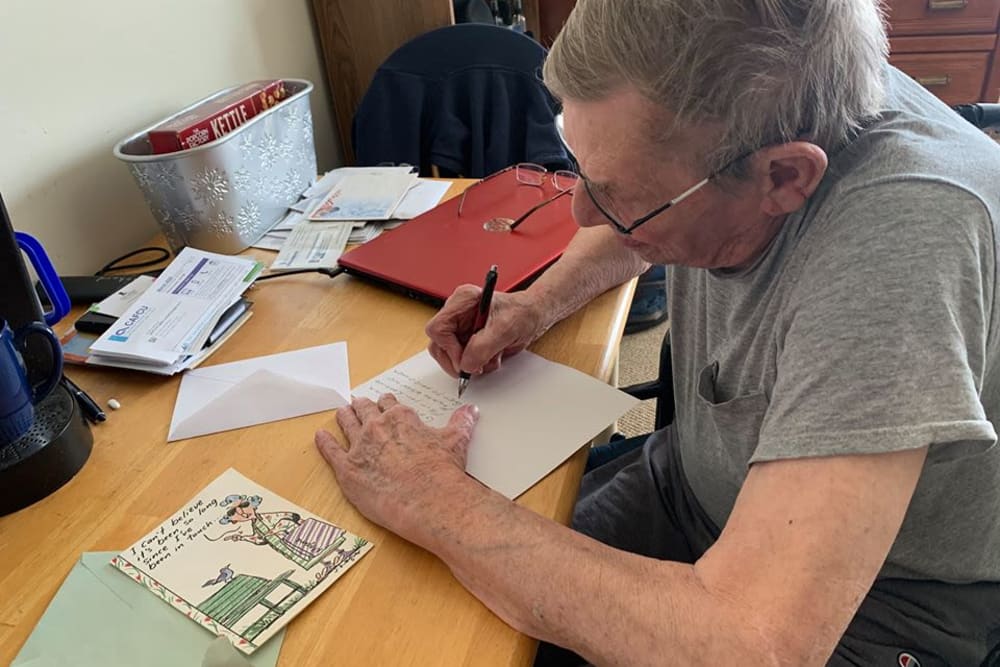 Resident writing letter at Oak Hill Supportive Living Community in Round Lake Beach, Illinois