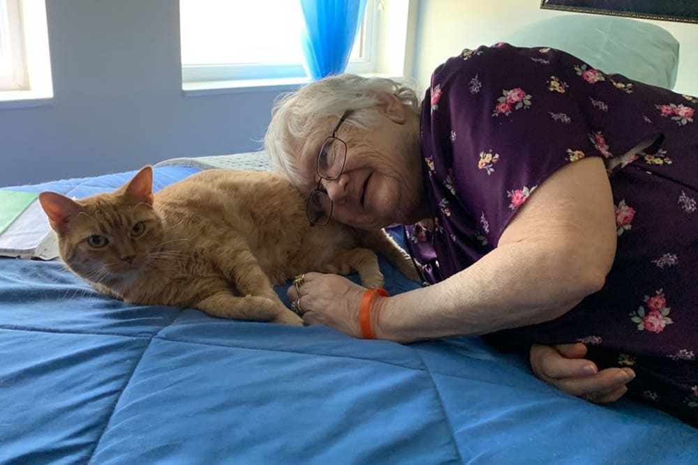 Resident with cat at Oak Hill Supportive Living Community in Round Lake Beach, Illinois