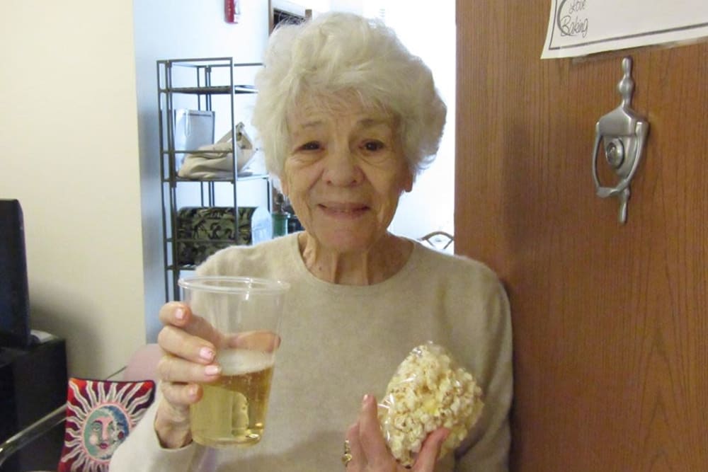 Resident with beverage and popcorn at Victory Centre of Vernon Hills