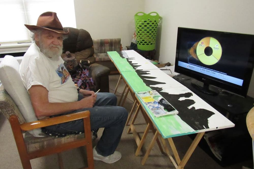 Resident working on painting at Victory Centre of Galewood