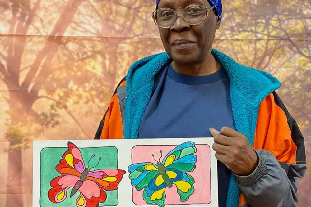 Resident with painting at Victory Centre of Roseland 