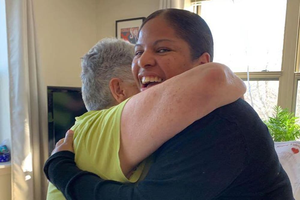 Resident giving a hug at Victory Centre of River Woods 