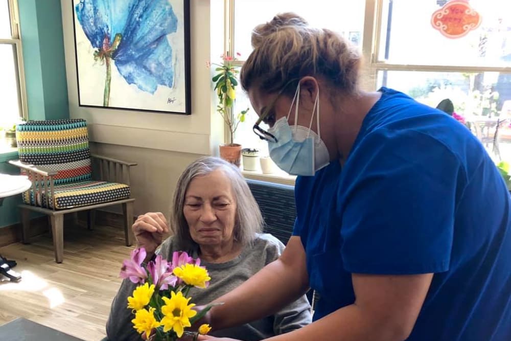 Putting flowers in a vase at Aspired Living of Prospect Heights in Prospect Heights, Illinois. 