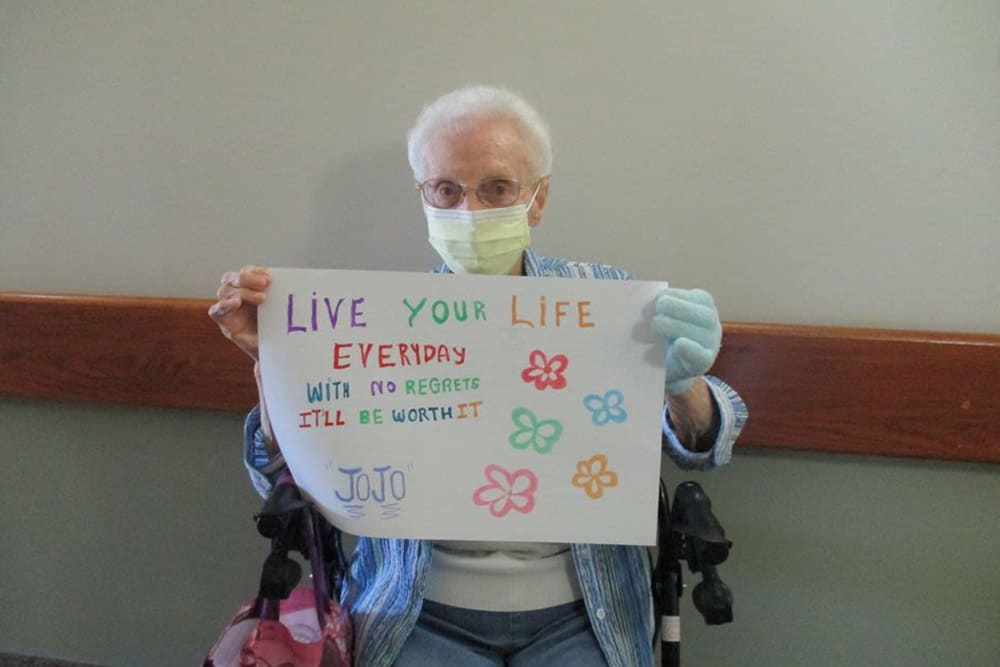 Resident with poster at Victory Centre of Park Forest