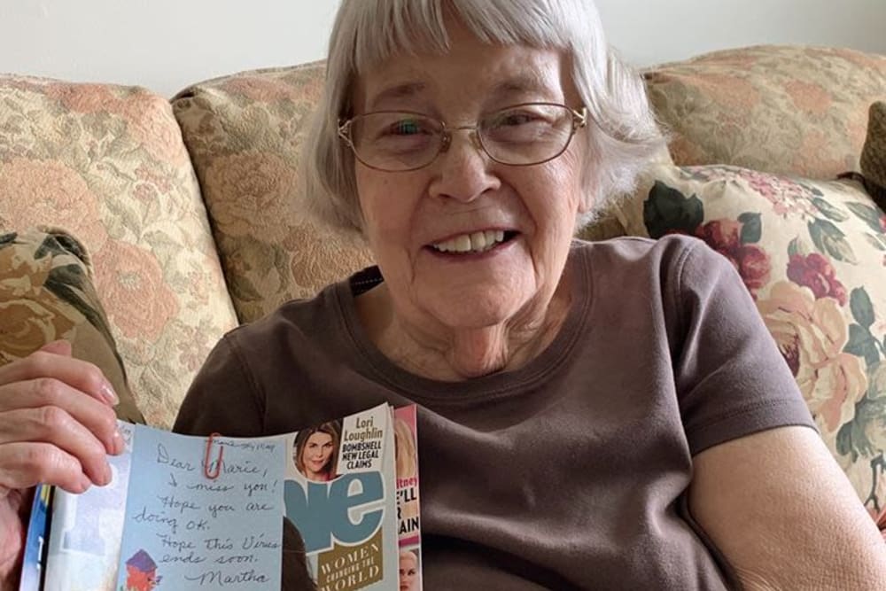 Resident with letter at Oak Hill Supportive Living Community in Round Lake Beach, Illinois