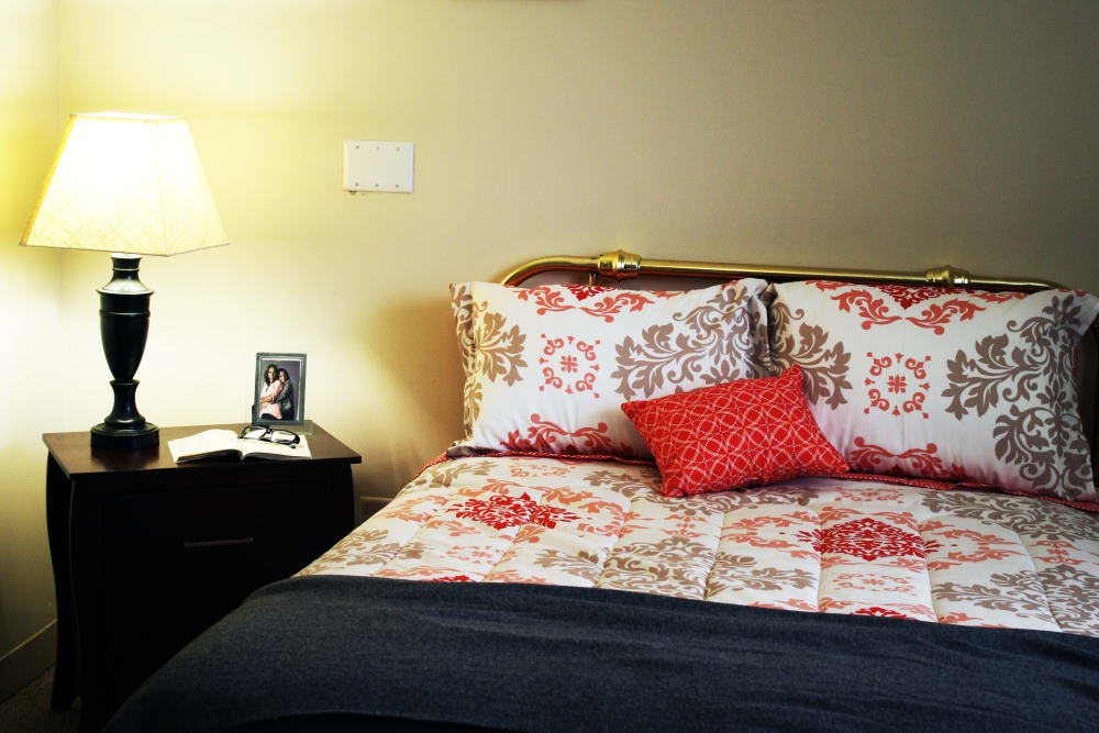 bed and nightstand with lamp