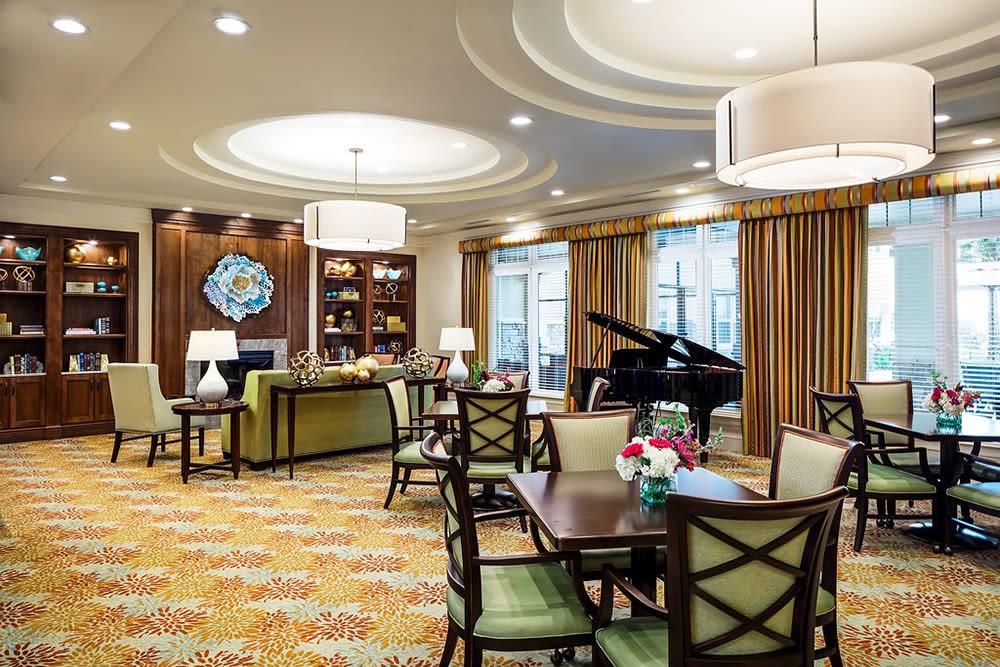 Community seating by a piano at Azpira at Windermere in Windermere, Florida | Pathway to Living