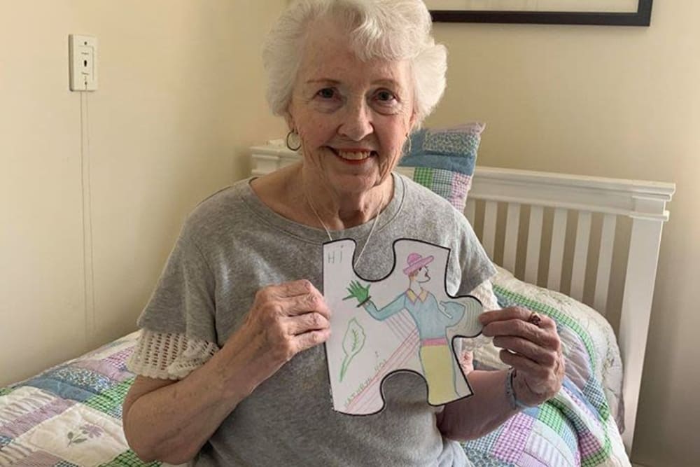 Resident with drawing at Victory Centre of River Woods 