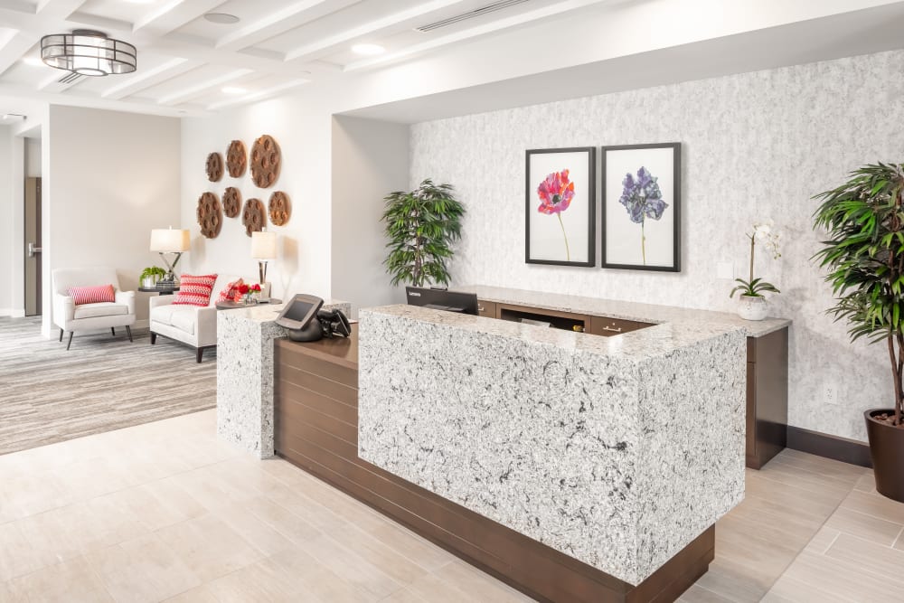 Reception area with a ornate marble and wood desk at Aspired Living of La Grange in La Grange, Illinois