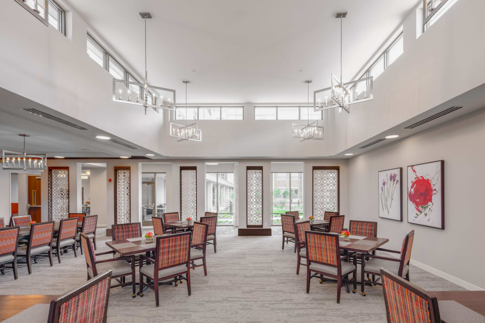 Evenly lit dining area with several spaced out dining tables at Aspired Living of La Grange in La Grange, Illinois