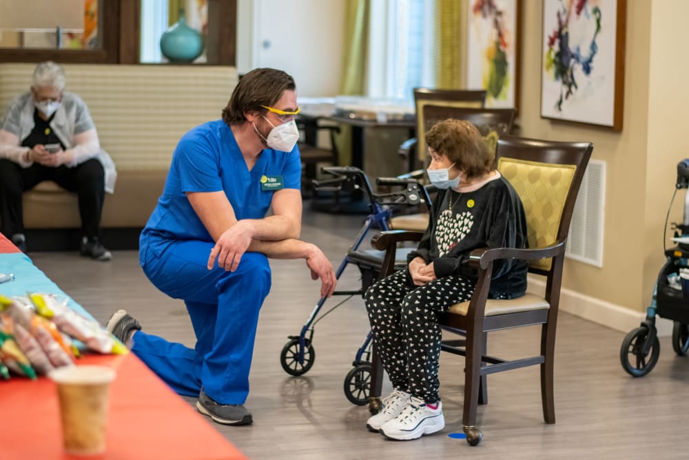 senior resident speaking with a nurse