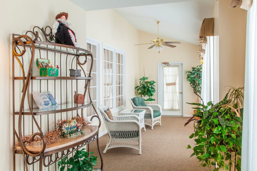 Charming sunroom complete with seating at Grand Victorian of Rockford in Rockford, Illinois