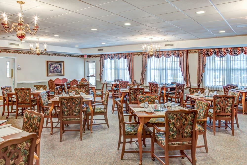 Dining room complete with chandeliers at Grand Victorian of Rockford in Rockford, Illinois