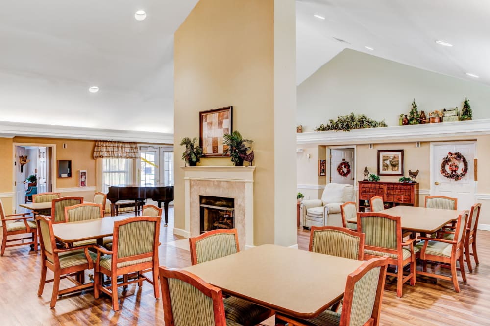 Community dining area with wood accents and fireplace at Carriage Court of Washington Court House in Washington Court House, Ohio