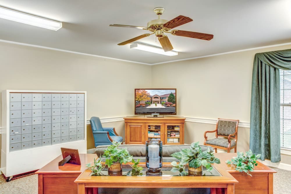 Sitting area with wood accents and television set at Carriage Court of Lancaster in Lancaster, Ohio