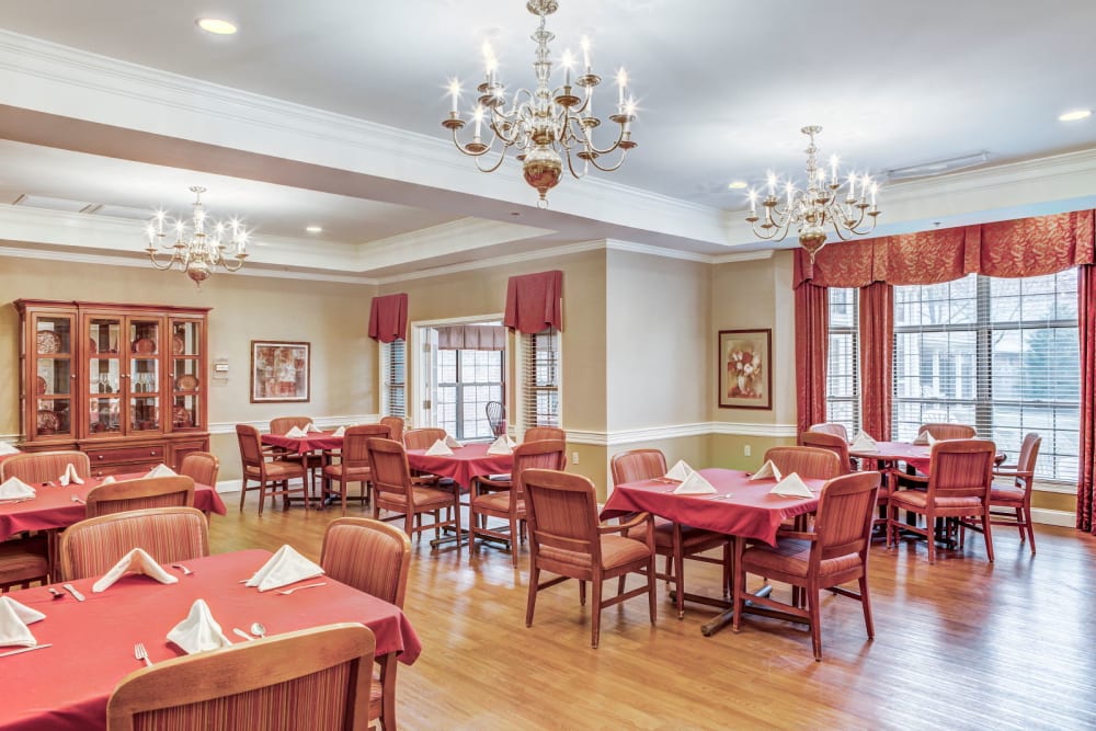 Ornate dining room  with wood accents and chandeliers at Carriage Court of Lancaster in Lancaster, Ohio