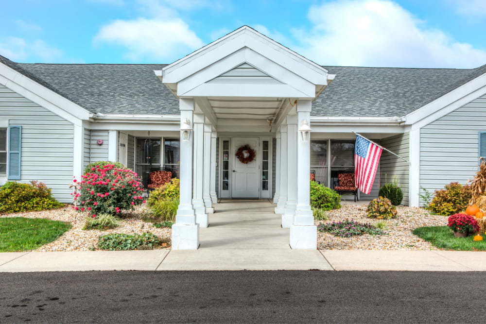 Front entrance on a sunny day to upscale senior living facility at Carriage Court of Grove City in Grove City, Ohio