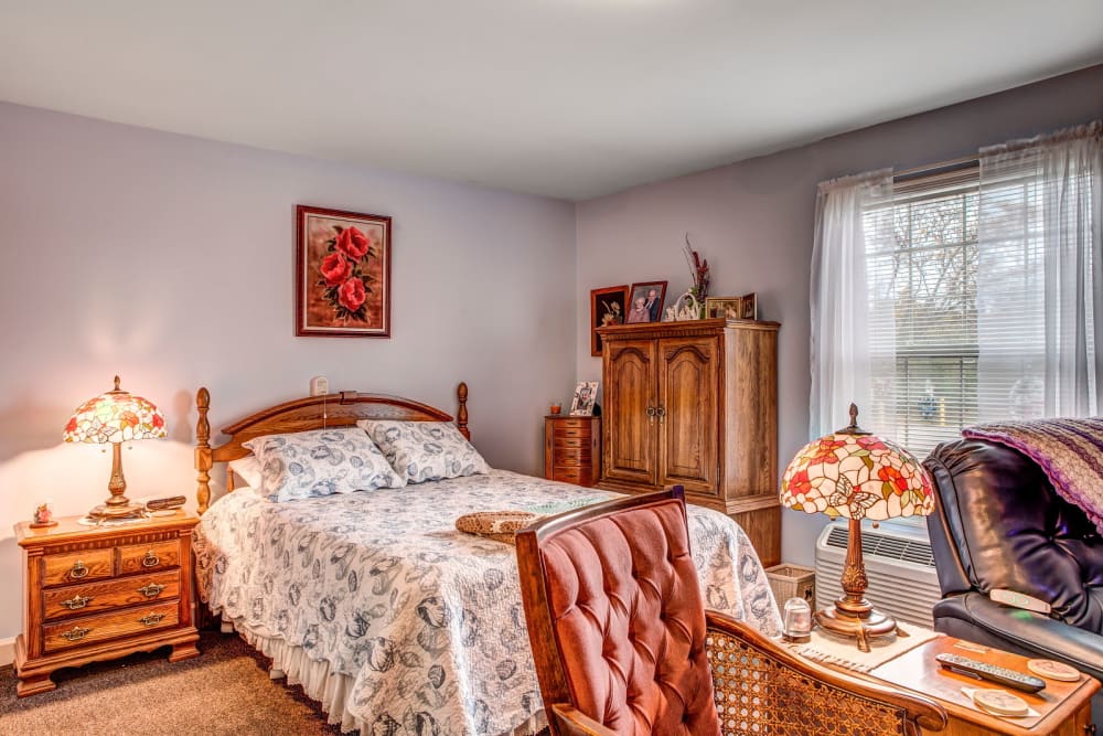 Cheerful bedroom in upscale senior living facility at Carriage Court of Grove City in Grove City, Ohio