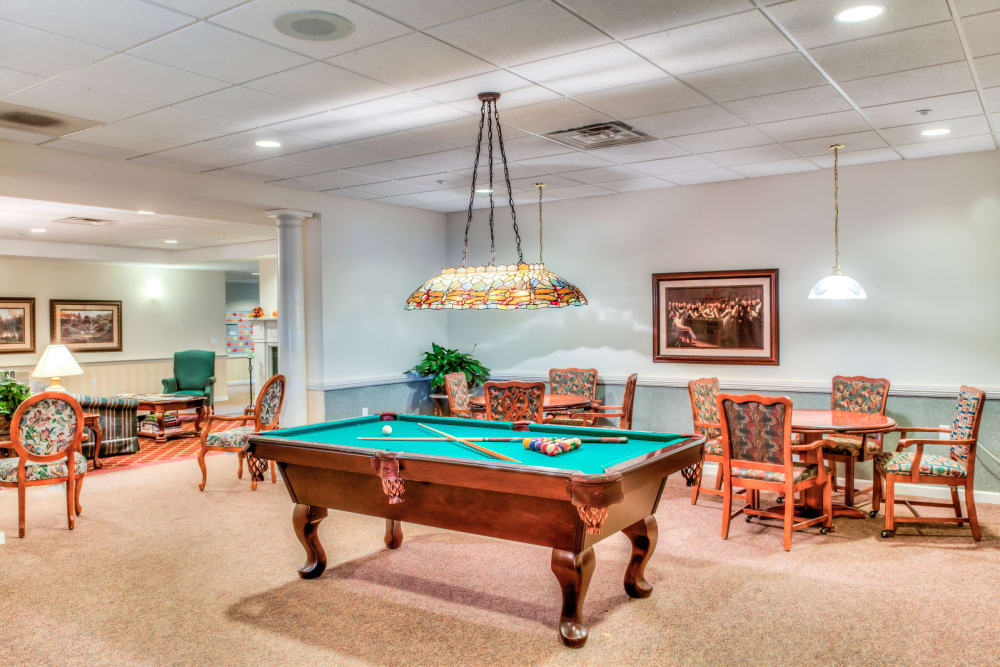 Activity and game room complete with large pool table at Grand Victorian of Sycamore in Sycamore, Illinois