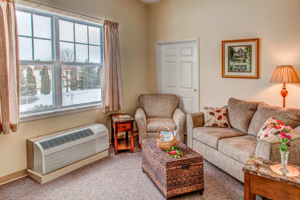 Cozy apartment with comfortable seating at Grand Victorian of Rockford in Rockford, Illinois