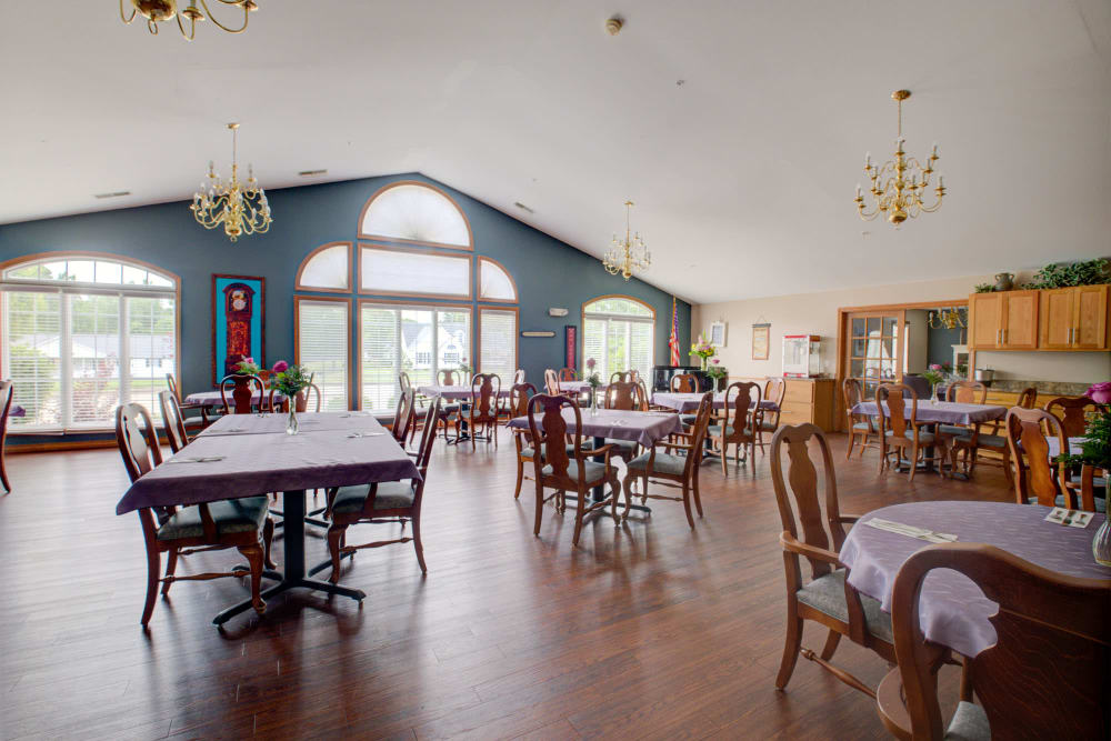 Elegant dinning with wood accents and chandeliers at Brookstone Estates of Vandalia in Vandalia, Illinois