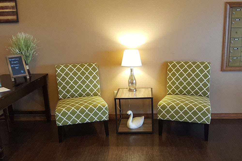 Cheerful lounge seating with bright lamp at Brookstone Estates of Robinson in Robinson, Illinois