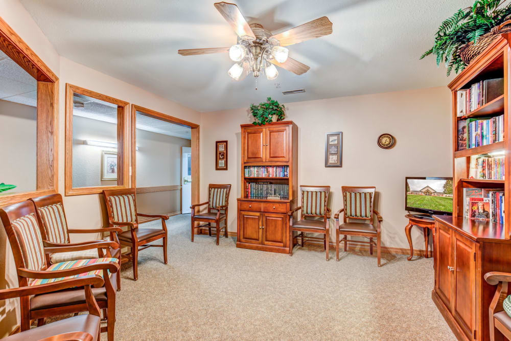 Brightly lit library complete with wood accents at Brookstone Estates of Rantoul in Rantoul, Illinois