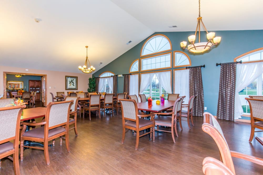 Elegant dining room complete with hardwood floor and chandeliers at Brookstone Estates of Rantoul in Rantoul, Illinois