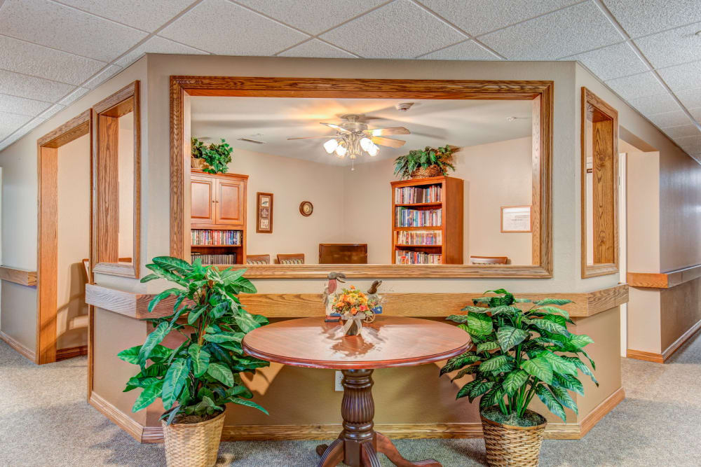 Lobby complete with wood accents and foliage at Brookstone Estates of Rantoul in Rantoul, Illinois