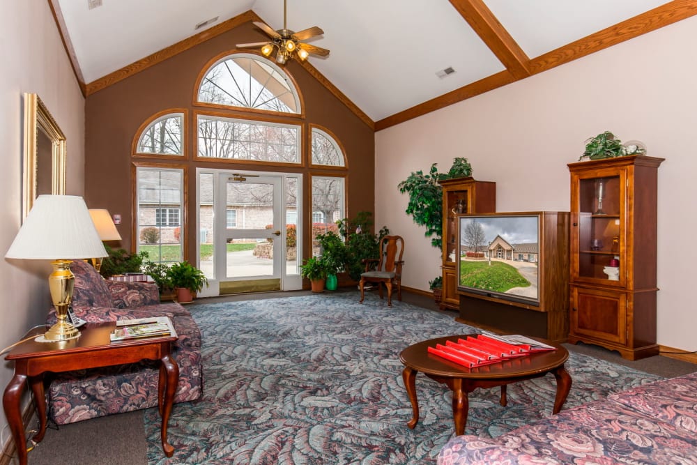 TV room with elegant wood accents and large window at Brookstone Estates of Paris in Paris, Illinois