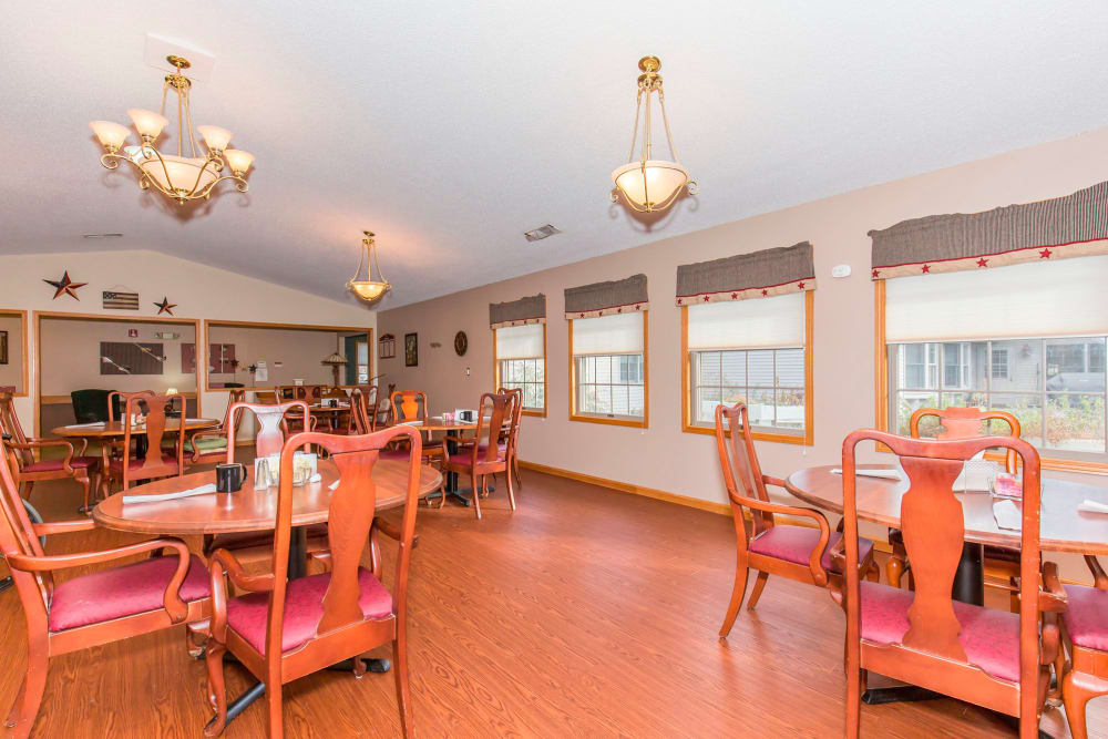 Elegant dining area complete with chandeliers at Emerald Glen of Olney in Olney, Illinois