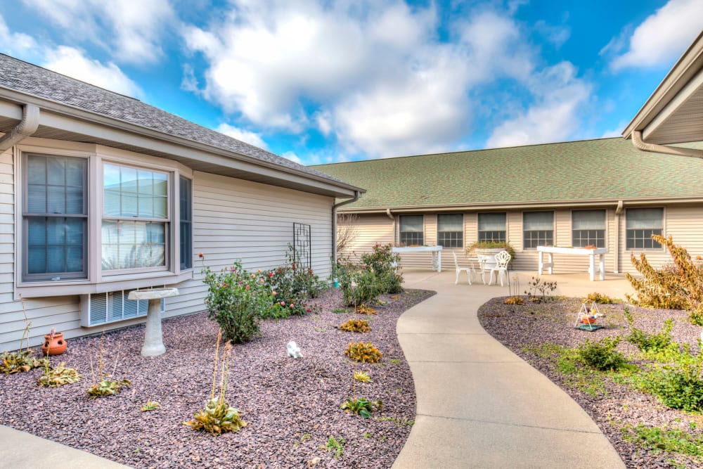 Sunny path leading up to upscale senior living facility at Emerald Glen of Olney in Olney, Illinois