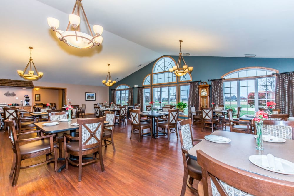 Elegant dining room with chandeliers at Brookstone Estates of Olney in Olney, Illinois