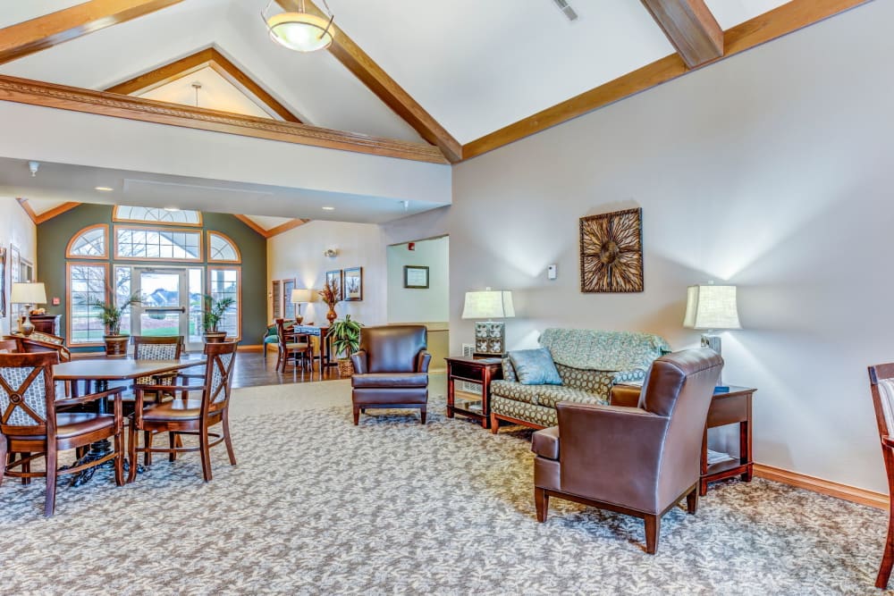Cozy sitting room with wood accents and arm chairs at Brookstone Estates of Olney in Olney, Illinois