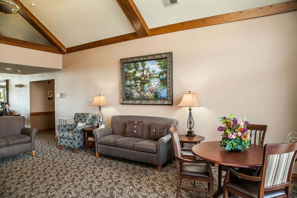 Beautiful living room complete with sofas and fireplace at Brookstone Estates of Mattoon South in Mattoon, Illinois