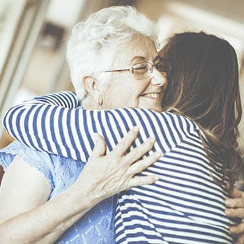 young woman hugging senior lady at Azpira Place of Breton