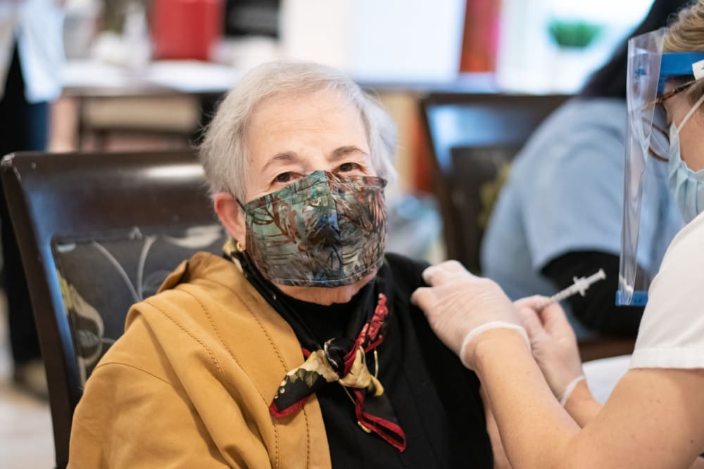 senior woman receiving a vaccine