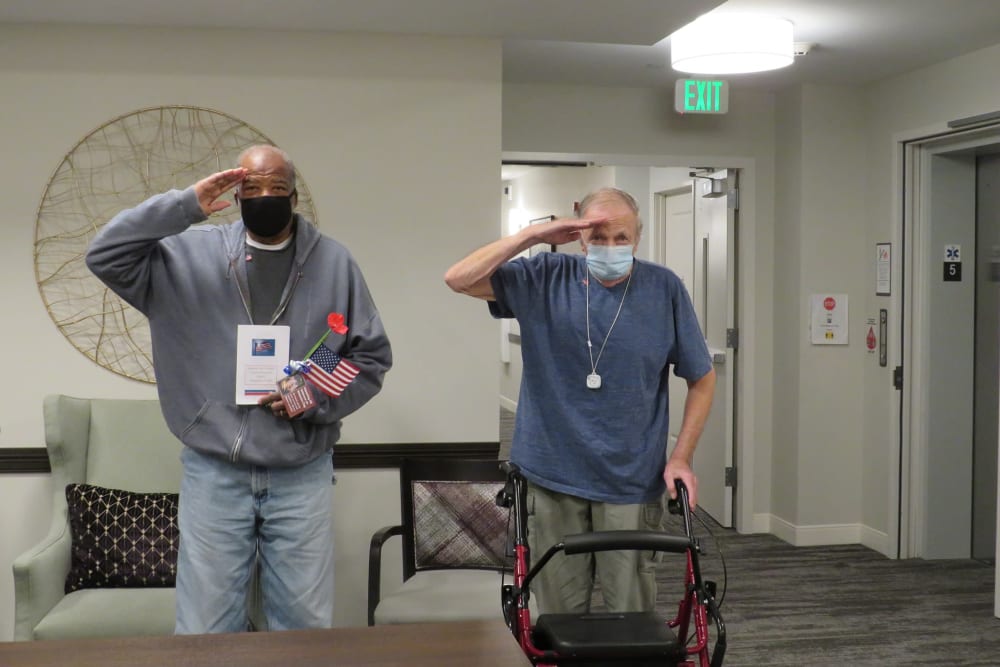 Two veteran residents standing and saluting at Aspired Living of La Grange in La Grange, Illinois