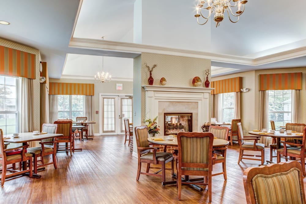 Ornate dining room complete with wood accents and chandeliers at Carriage Court of Grove City in Grove City, Ohio