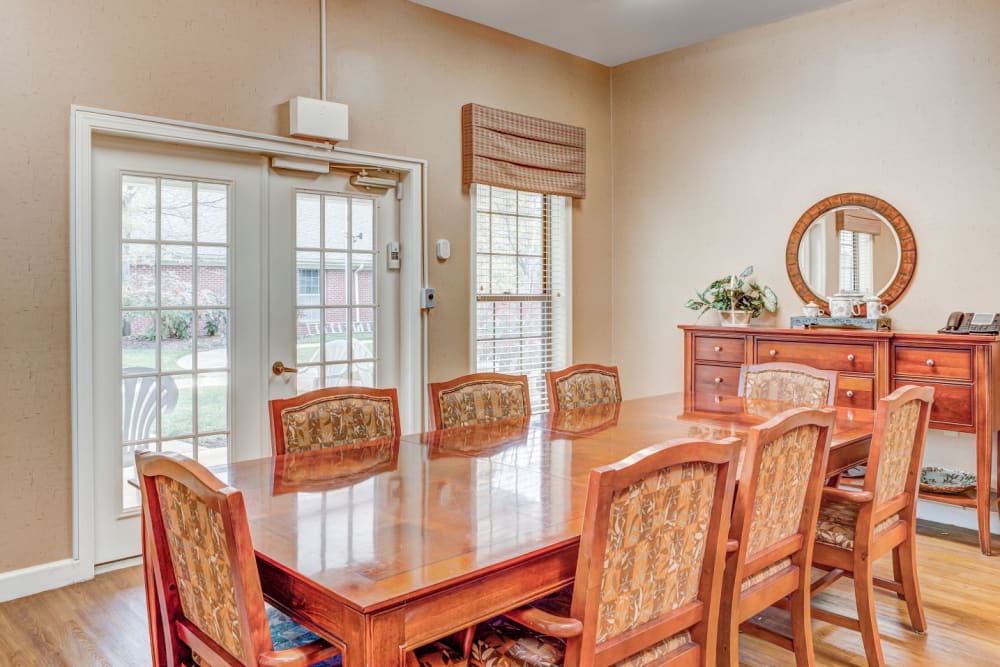 Large community dinning table with wood accents at Carriage Court of Lancaster in Lancaster, Ohio