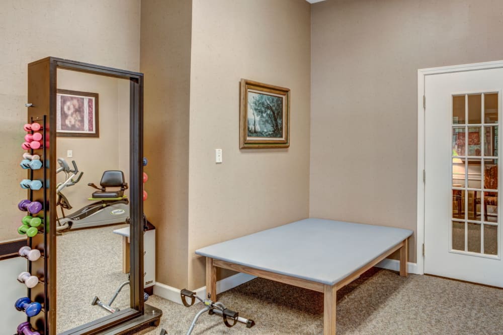 Fully equipment gym with machines and weight set at Carriage Court of Lancaster in Lancaster, Ohio
