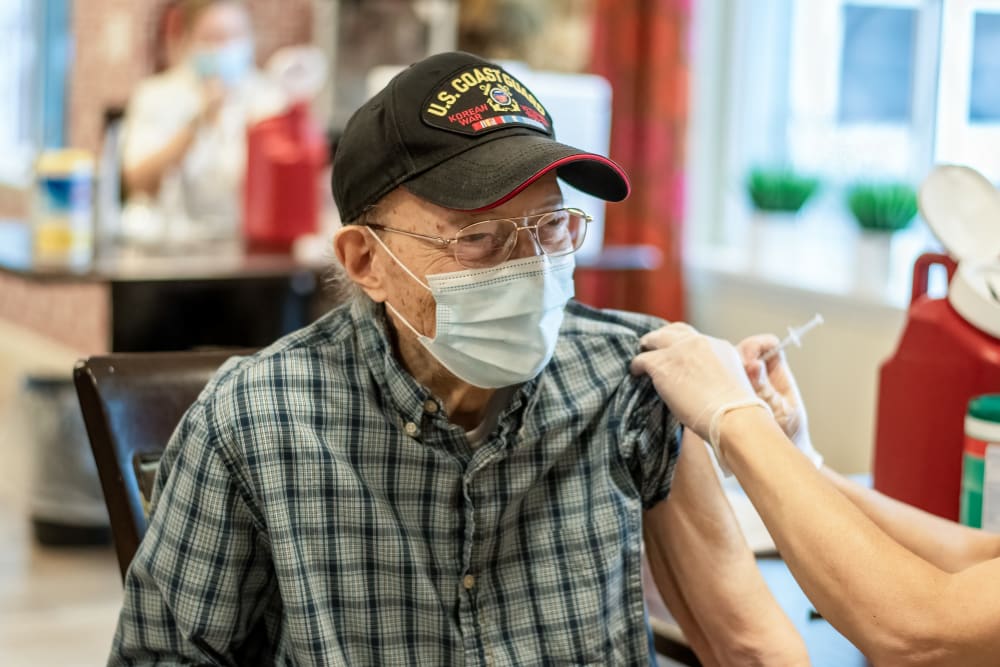 senior resident receiving a vaccine