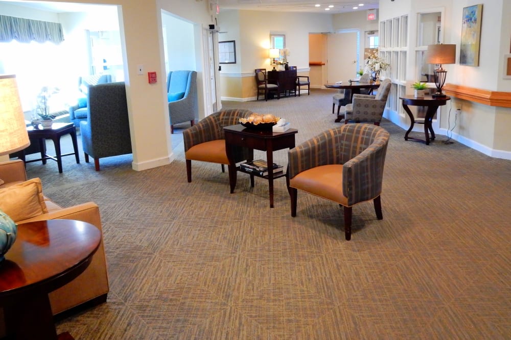 Lounge with elegant wood accents and ample seating at Carriage Court of Grove City in Grove City, Ohio