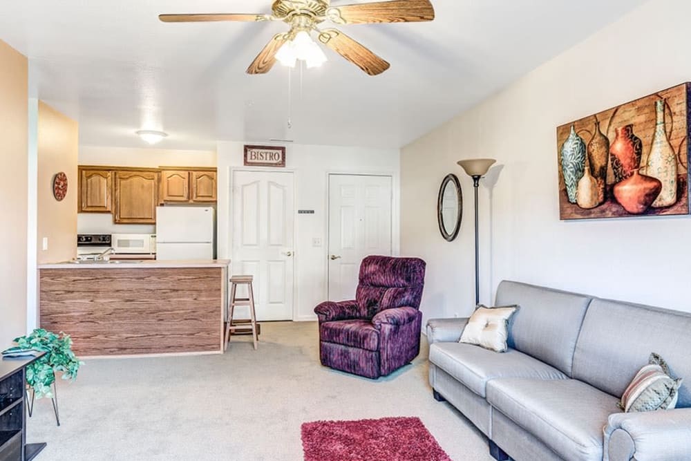 Cozy senior living apartment with arm chairs and ceiling fan at Brookstone Estates of Paris in Paris, Illinois
