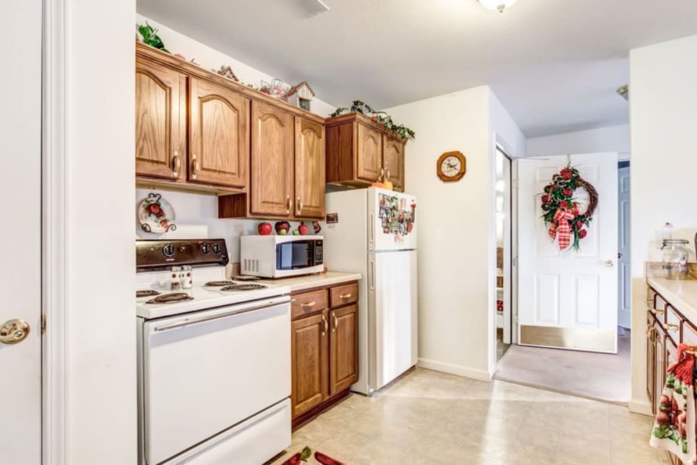 Kitchen of senior living apartment with wood accents at Brookstone Estates of Paris in Paris, Illinois