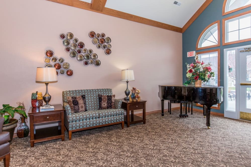 Sitting area complete with piano at Brookstone Estates of Tuscola in Tuscola, Illinois
